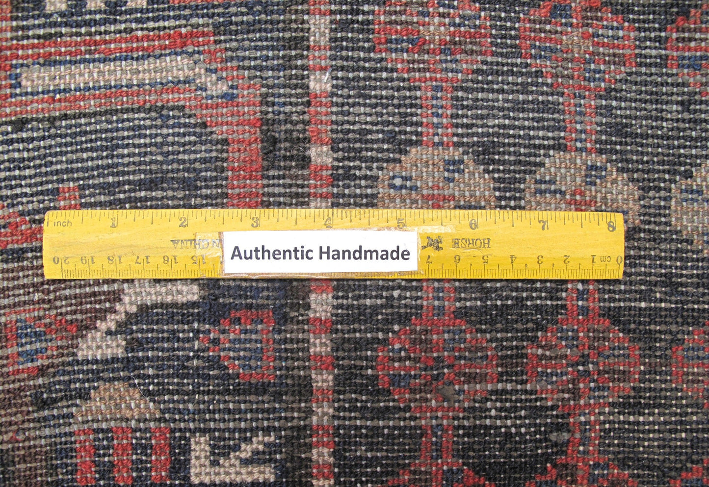 Tribal Hamadan-style small rug, pile texture and color depth close-up