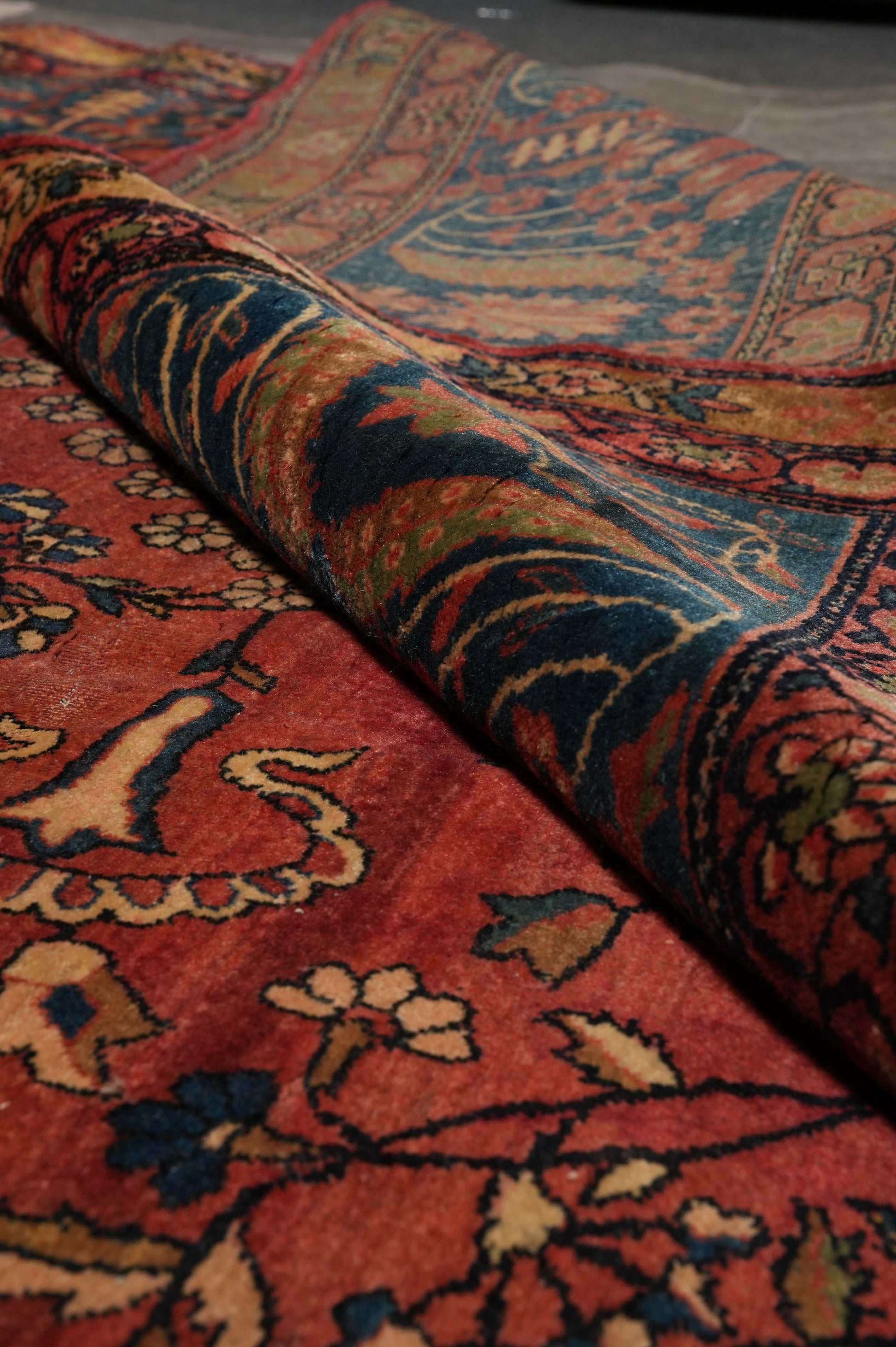 Antique Kashan-style rug, partial overhead view in natural light
