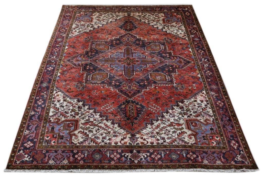 Classic Heriz-style wool rug, central medallion close-up in brick red, navy, and ivory