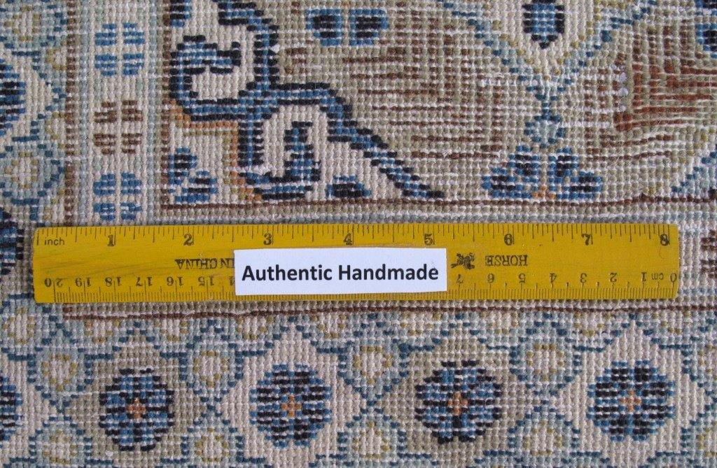 Signed Kashan-style ivory rug, color balance close-up showing ivory field