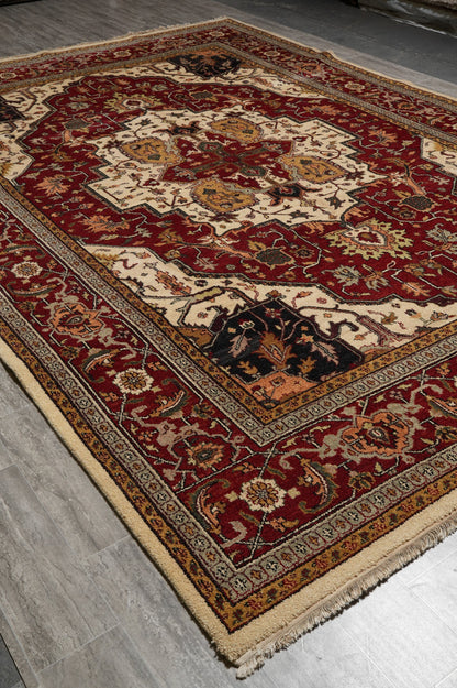 Heriz-Serapi-style wool rug, color contrast detail between burgundy field and ivory medallion