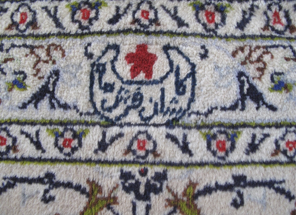 Signed Kashan-style palace rug, weaver signature panel close-up