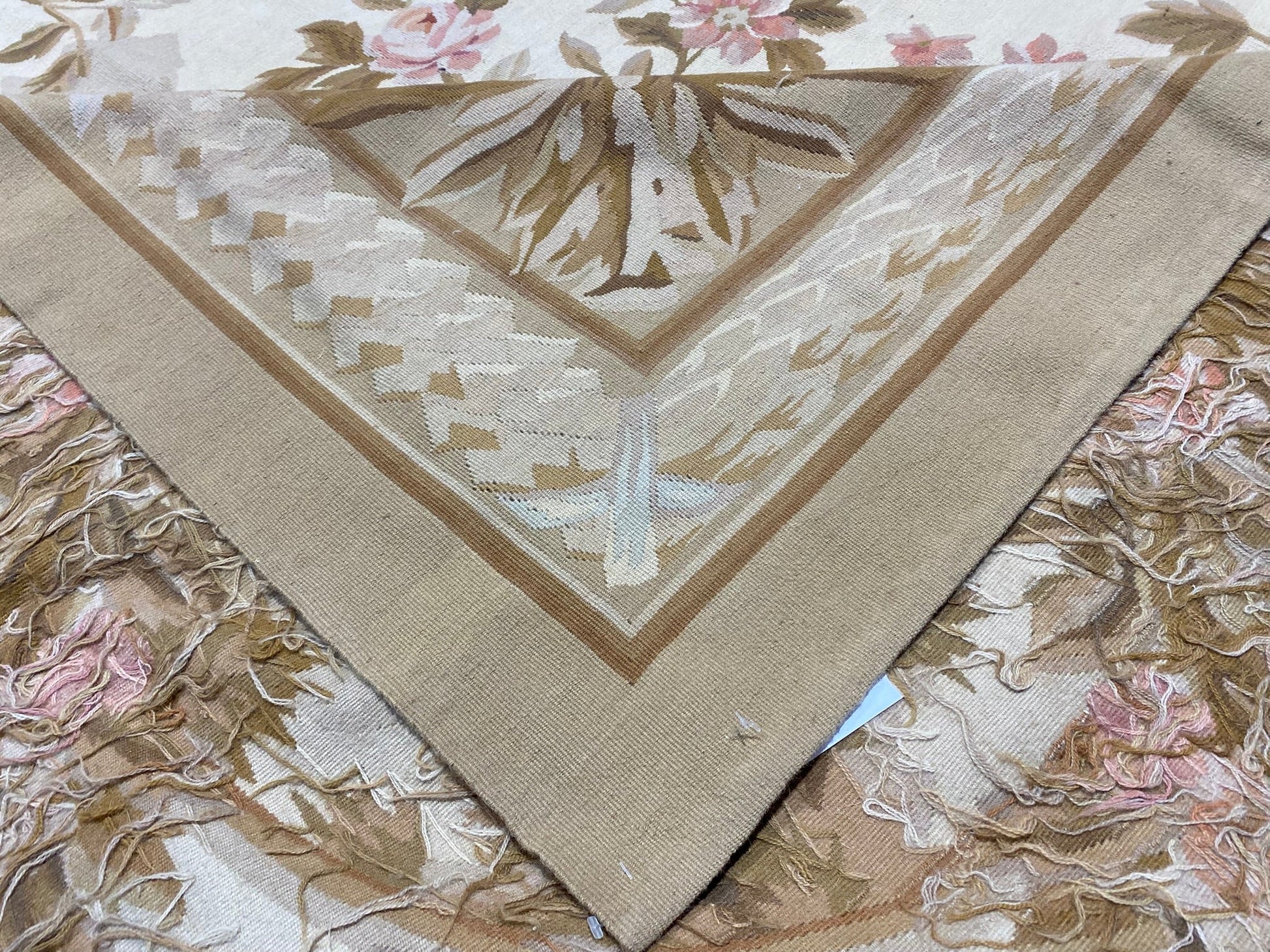 Aubusson floral rug, partial overhead view in natural light