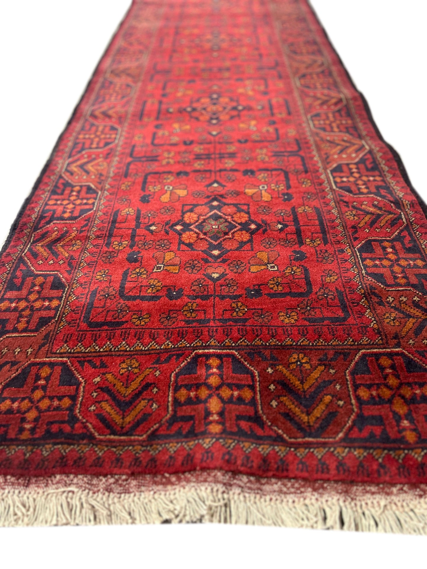 Afghan tribal runner, repeating medallion detail in red and ivory