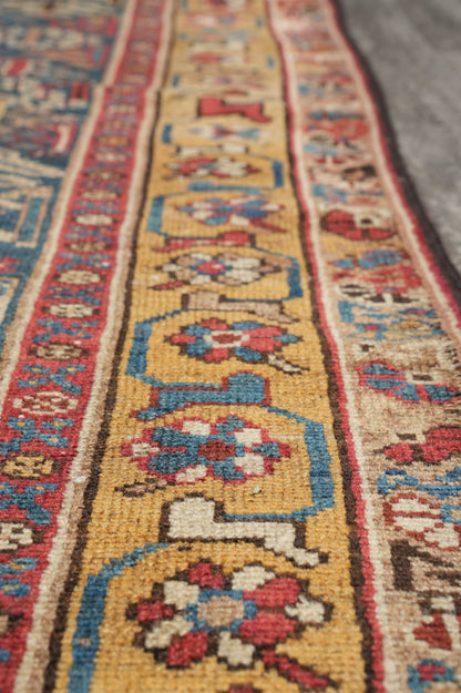 Antique 1940s Joshagan-pattern runner, color balance close-up showing aged red field