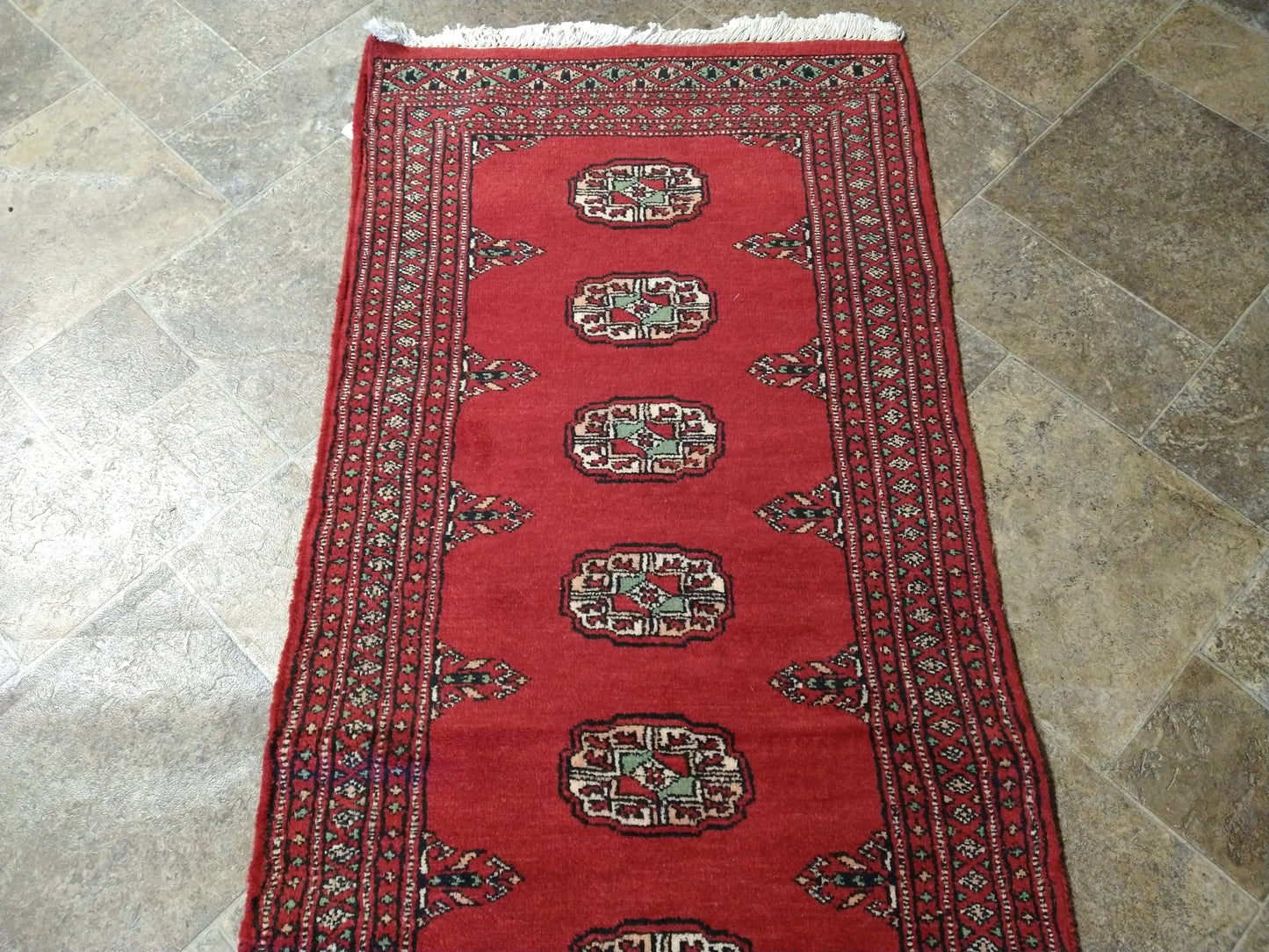 Bokhara runner, color balance close-up of red field against ivory borders