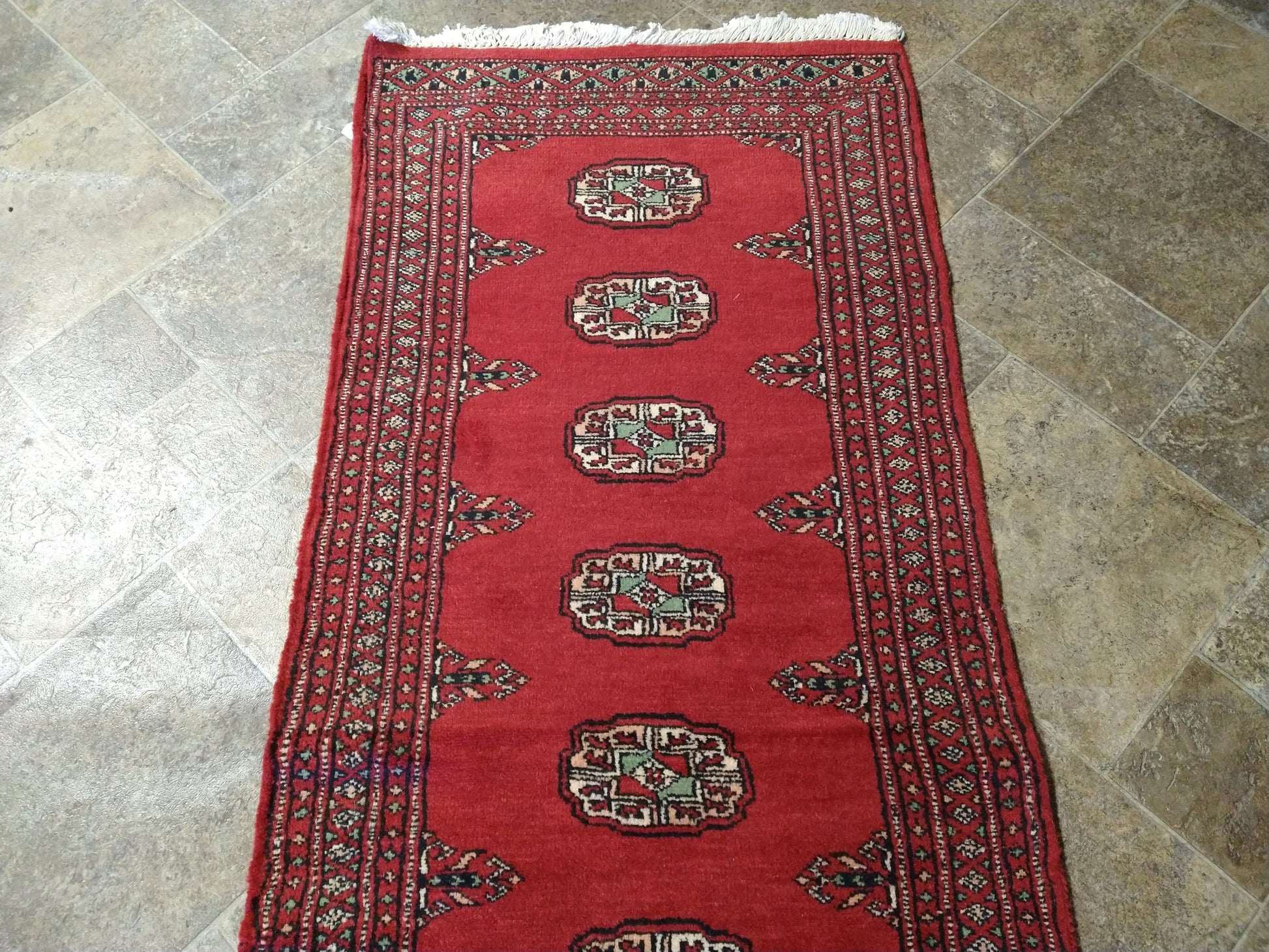 Bokhara runner, color balance close-up of red field against ivory borders