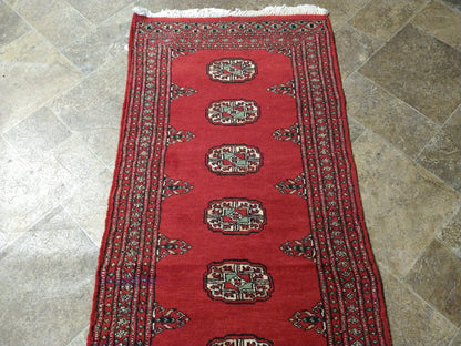Bokhara runner, color balance close-up of red field against ivory borders