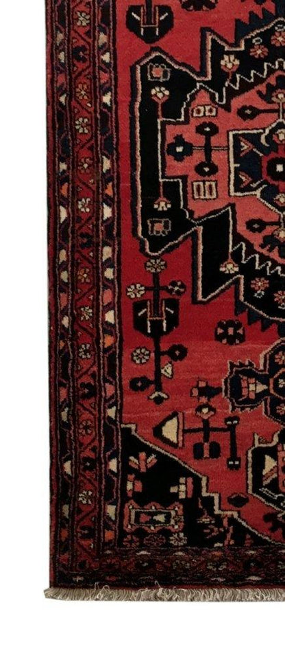 Rust red Hamadan-style runner, end-finish and fringe close-up