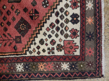 Pink Hamadan-style small rug, corner detail with geometric tribal motifs