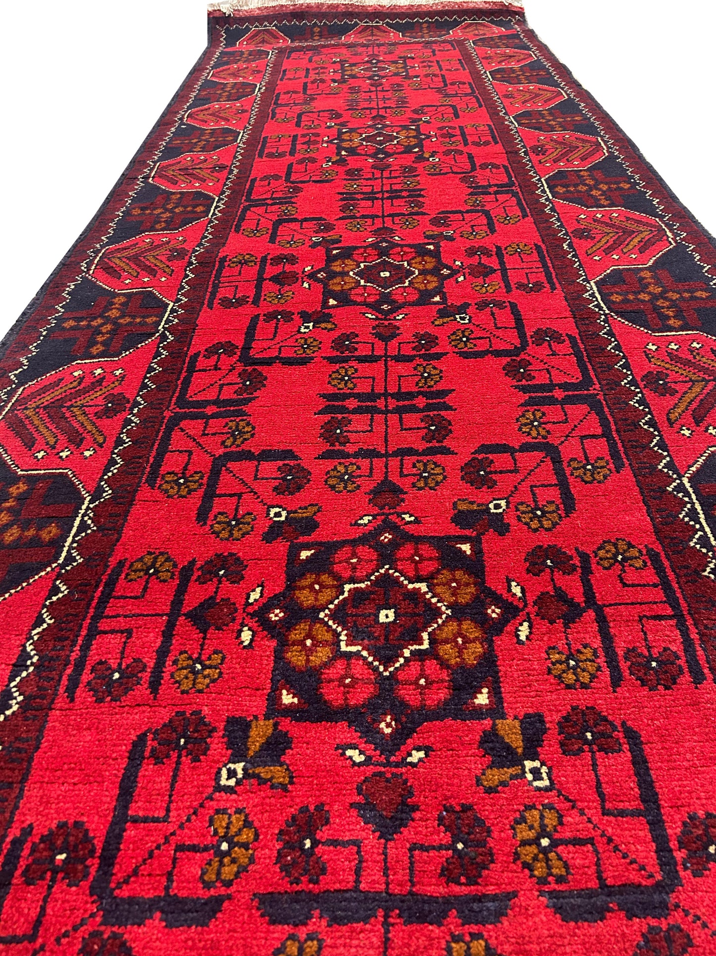 Afghan wool runner, mid-length pattern close-up showing tribal motifs