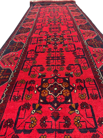 Afghan wool runner, mid-length pattern close-up showing tribal motifs