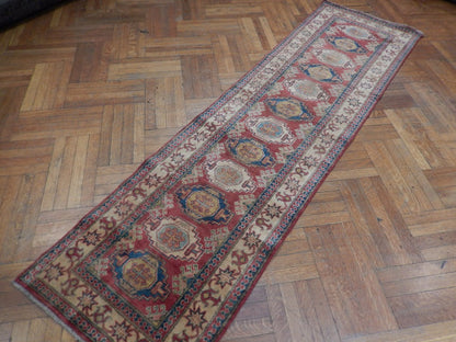 Kazak runner, mid-length pattern close-up in red and ivory