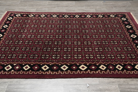 Turkman Bokhara burgundy rug, central gul medallion close-up on black field