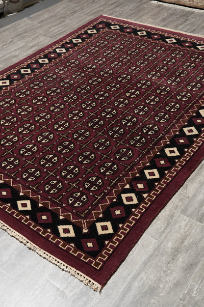 Turkman Bokhara burgundy rug, ivory border pattern detail