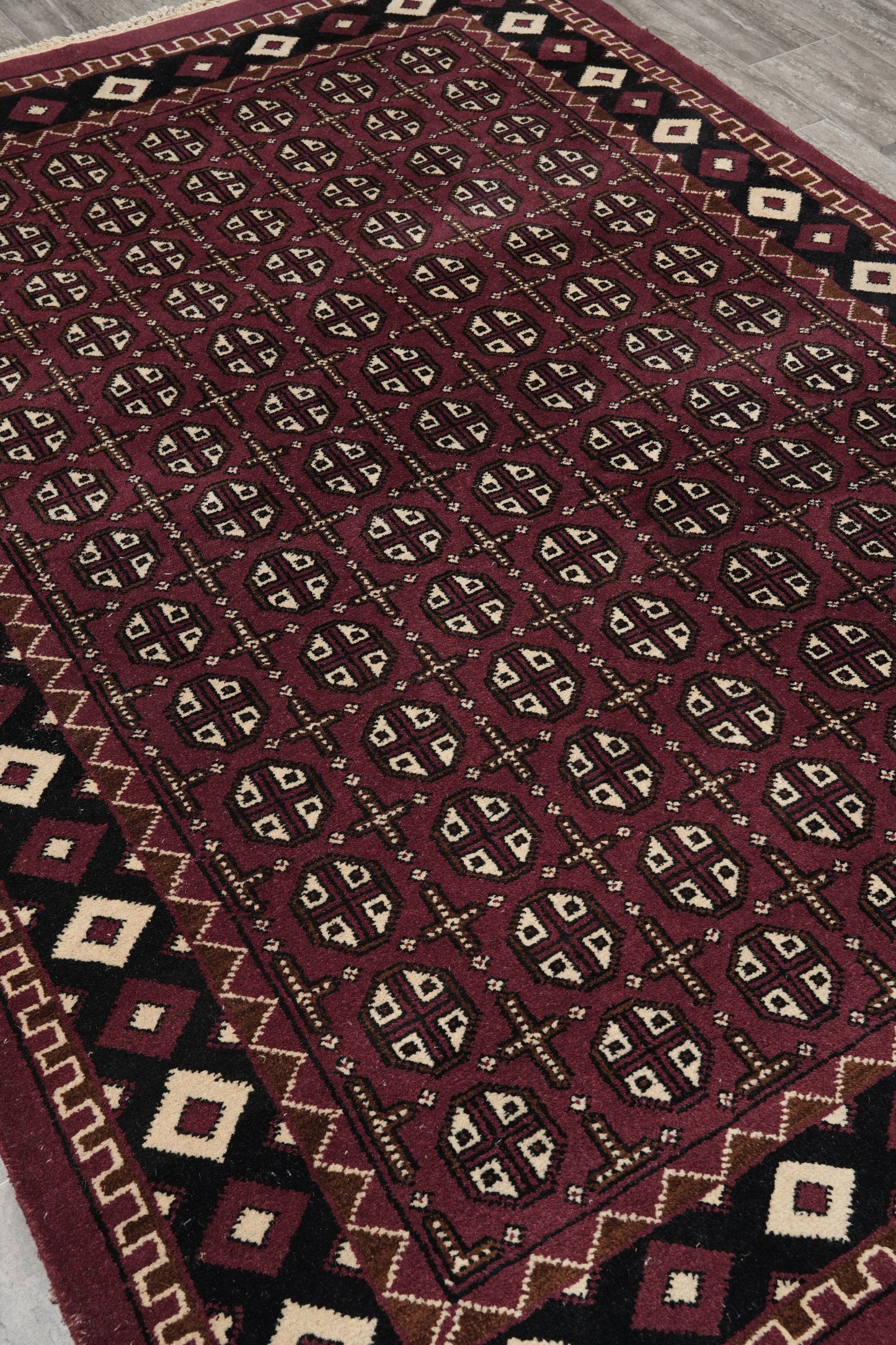 Turkman Bokhara burgundy rug, corner motif close-up