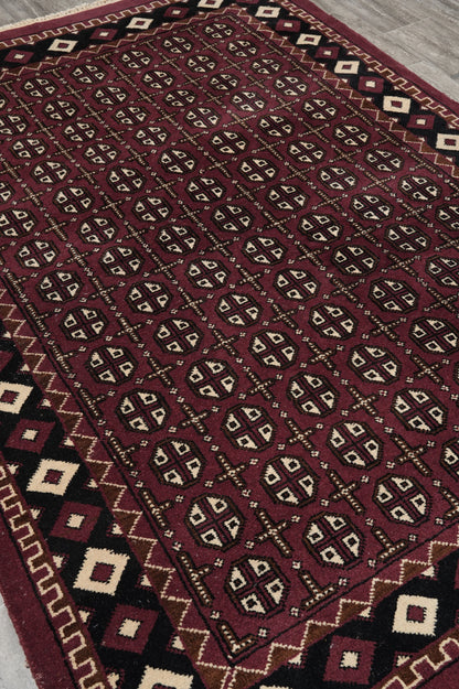 Turkman Bokhara burgundy rug, corner motif close-up