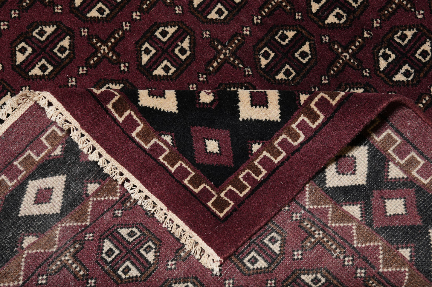 Turkman Bokhara burgundy rug, mid-field detail showing color depth