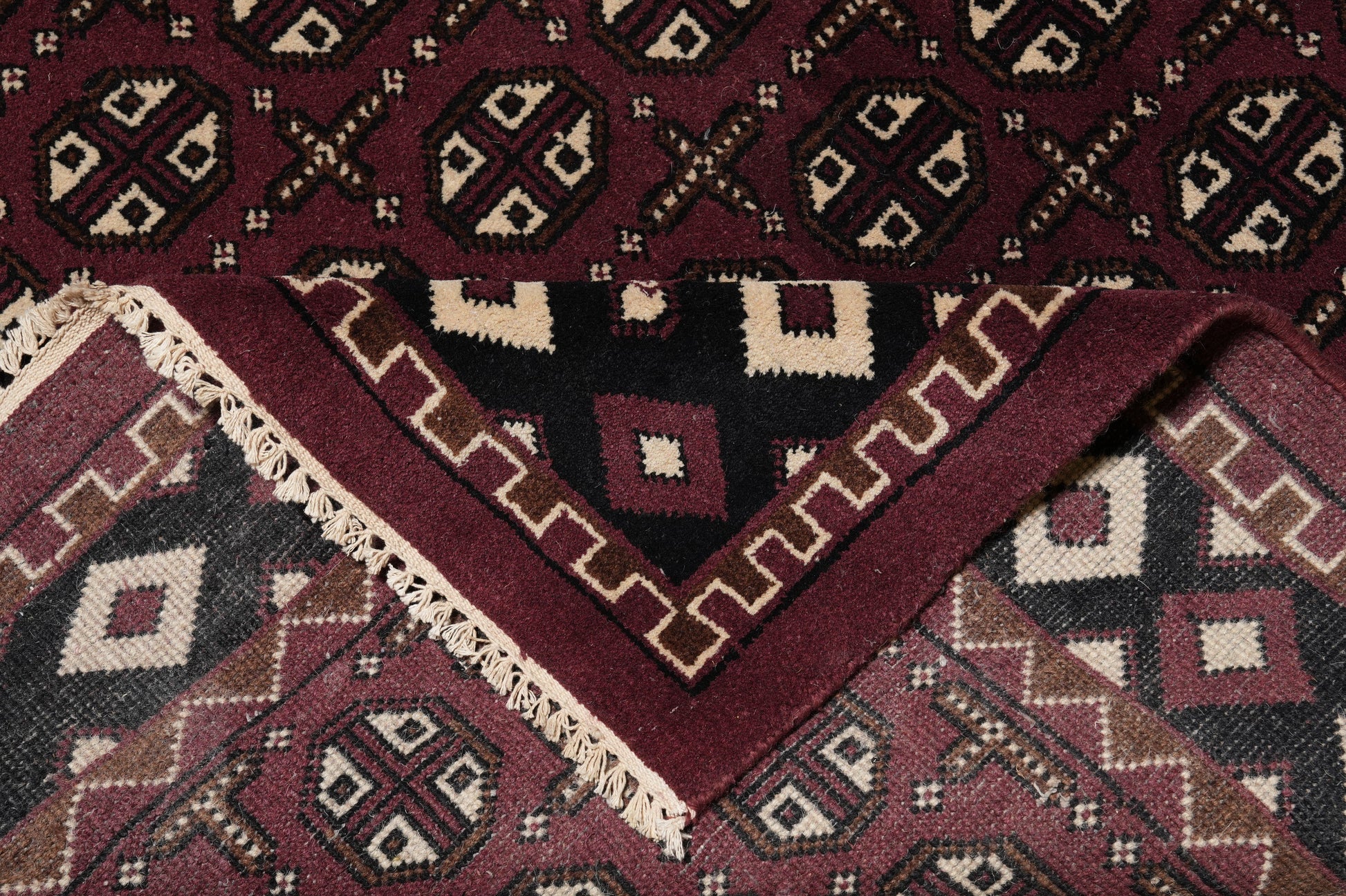 Turkman Bokhara burgundy rug, mid-field detail showing color depth