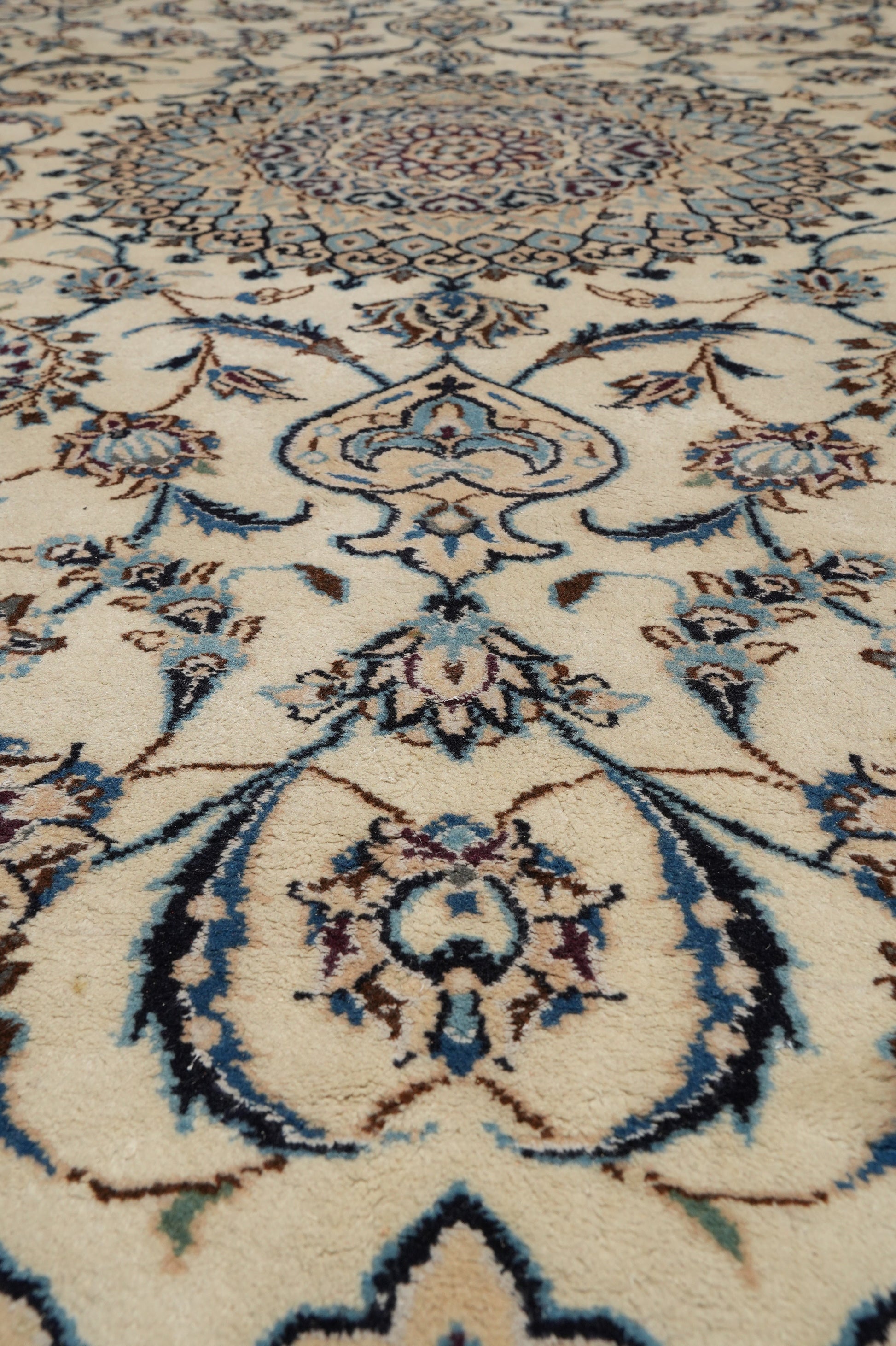 Tabriz-style ivory rug, color balance showing ivory field