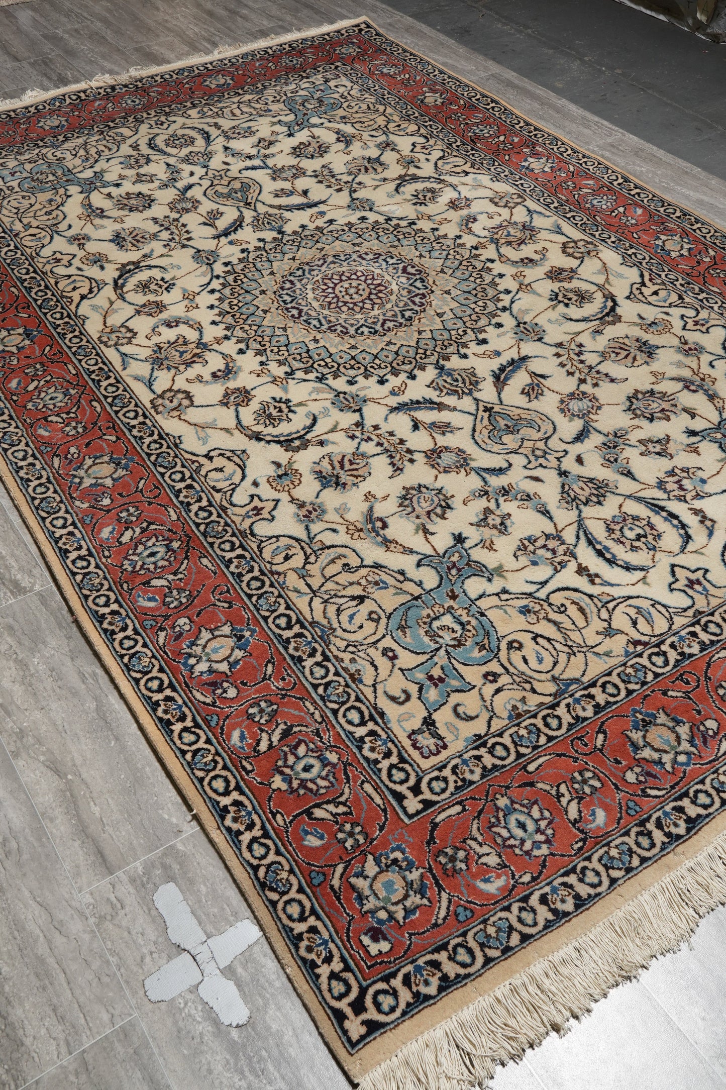Tabriz-style ivory rug, pile texture showing fine wool