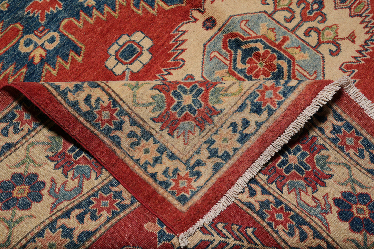 Afghan Kazak rug, color balance close-up showing rust and navy accents