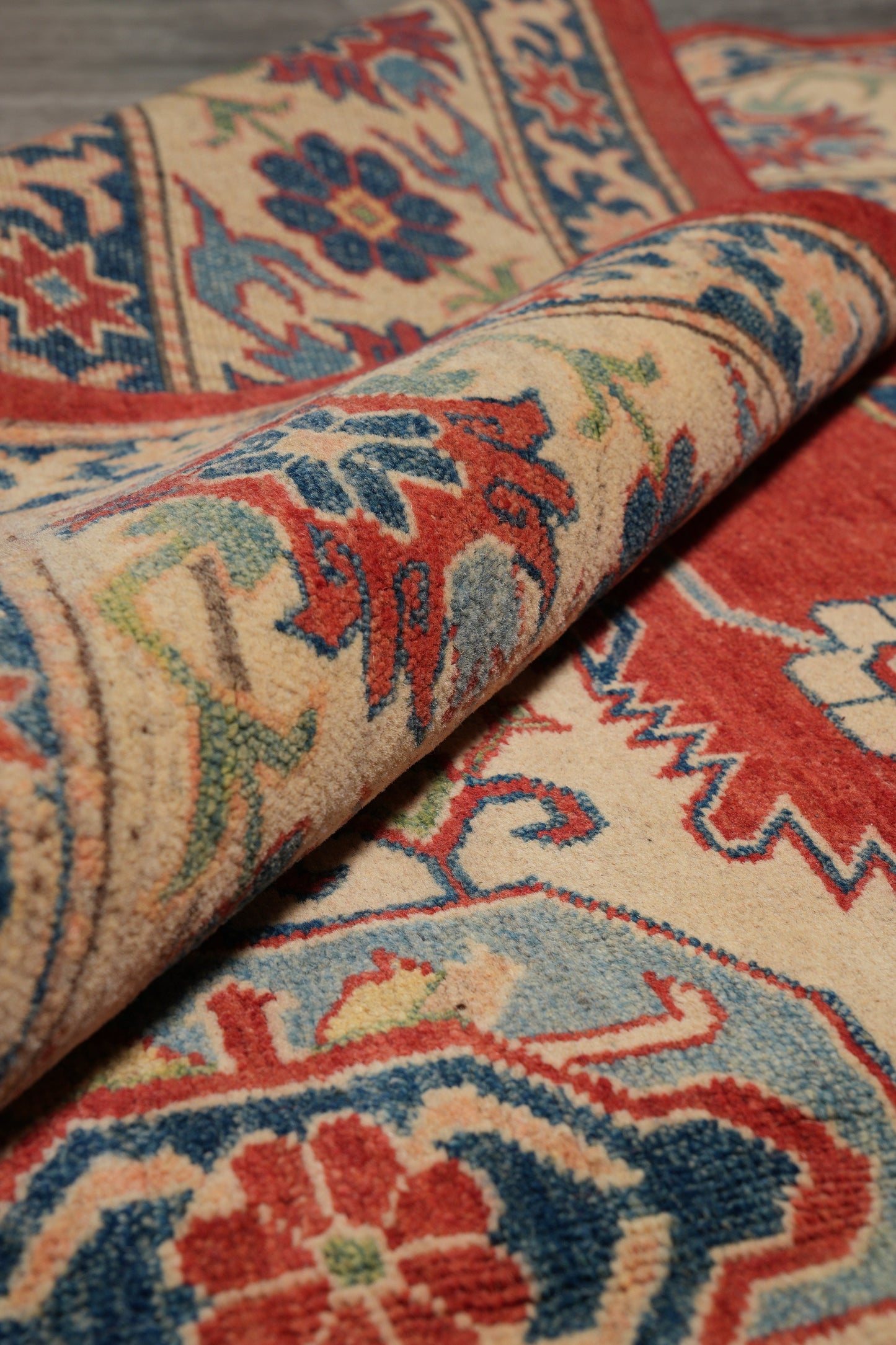 Afghan Kazak rug, mid-field detail with multi-color motifs