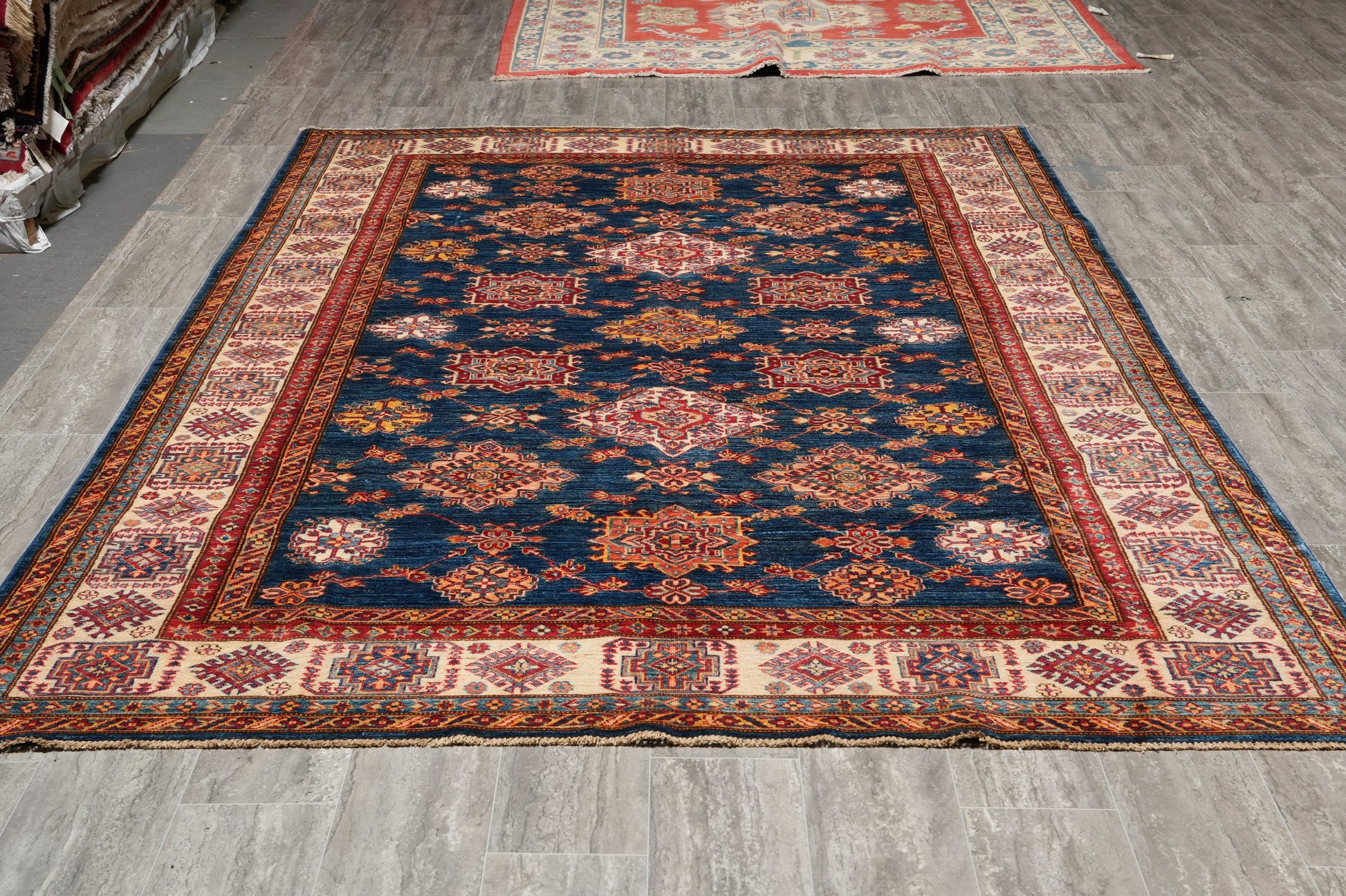 Silky navy Super Kazak rug, ivory and red tribal motif detail