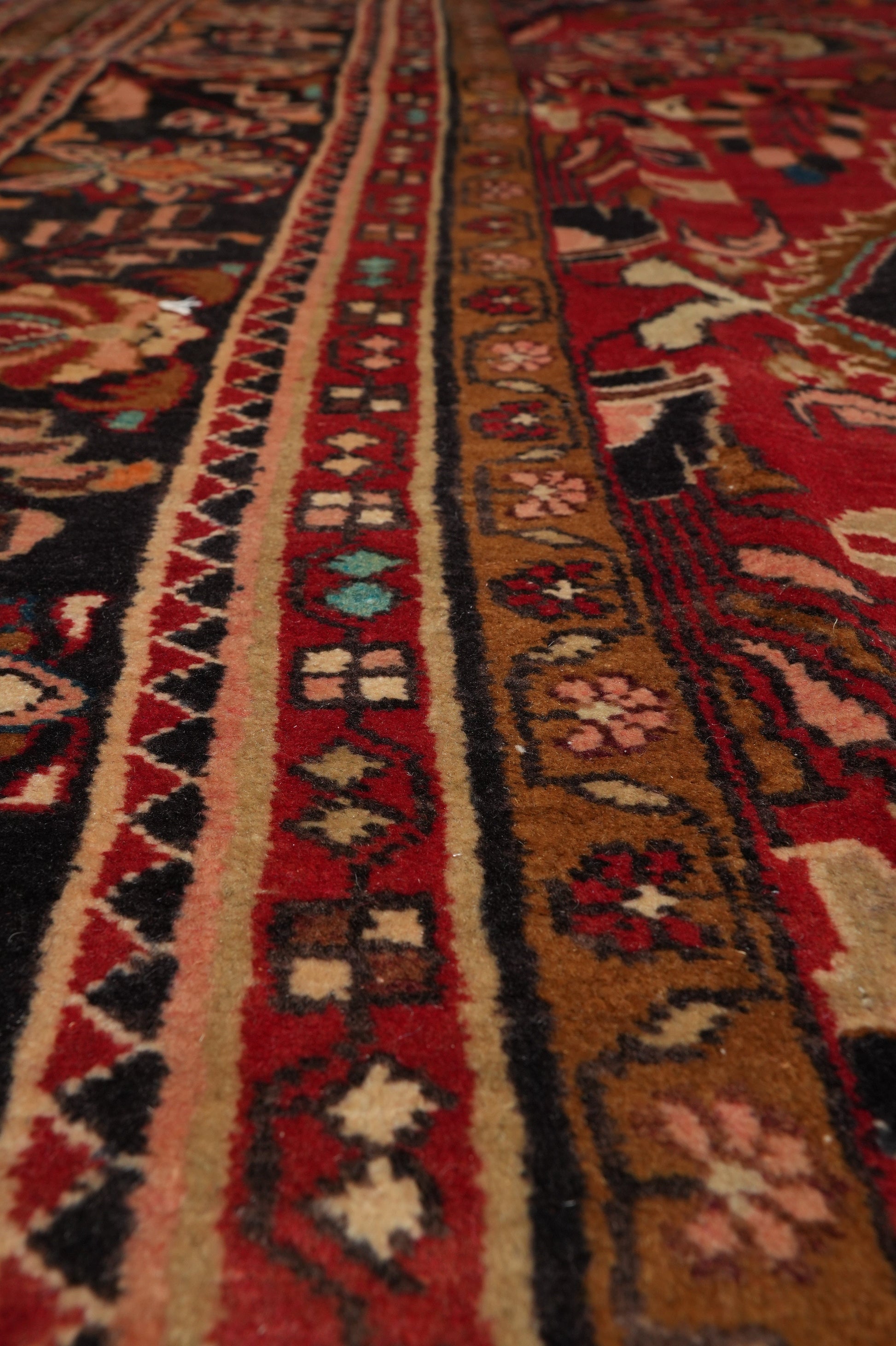 Semi-antique traditional floral rug, color balance close-up showing red depth