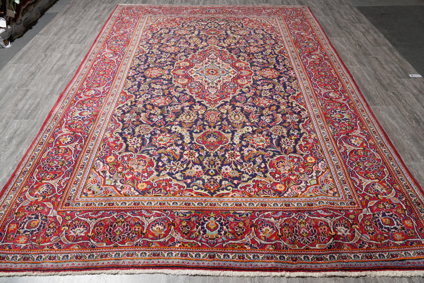 Kashan-style navy rug, central ivory medallion close-up
