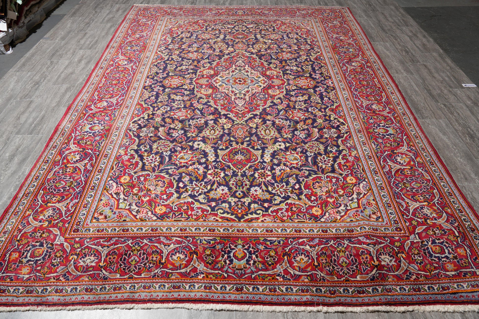 Kashan-style navy rug, central ivory medallion close-up