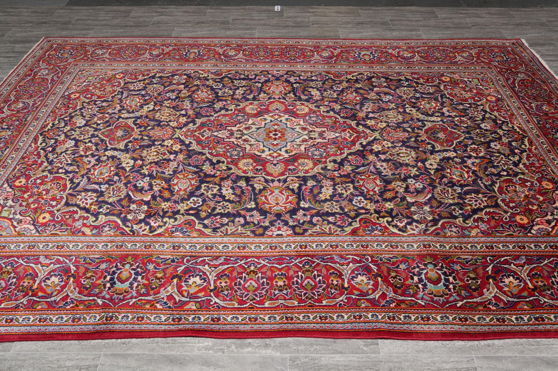 Kashan-style navy rug, curvilinear floral detail in red and ivory