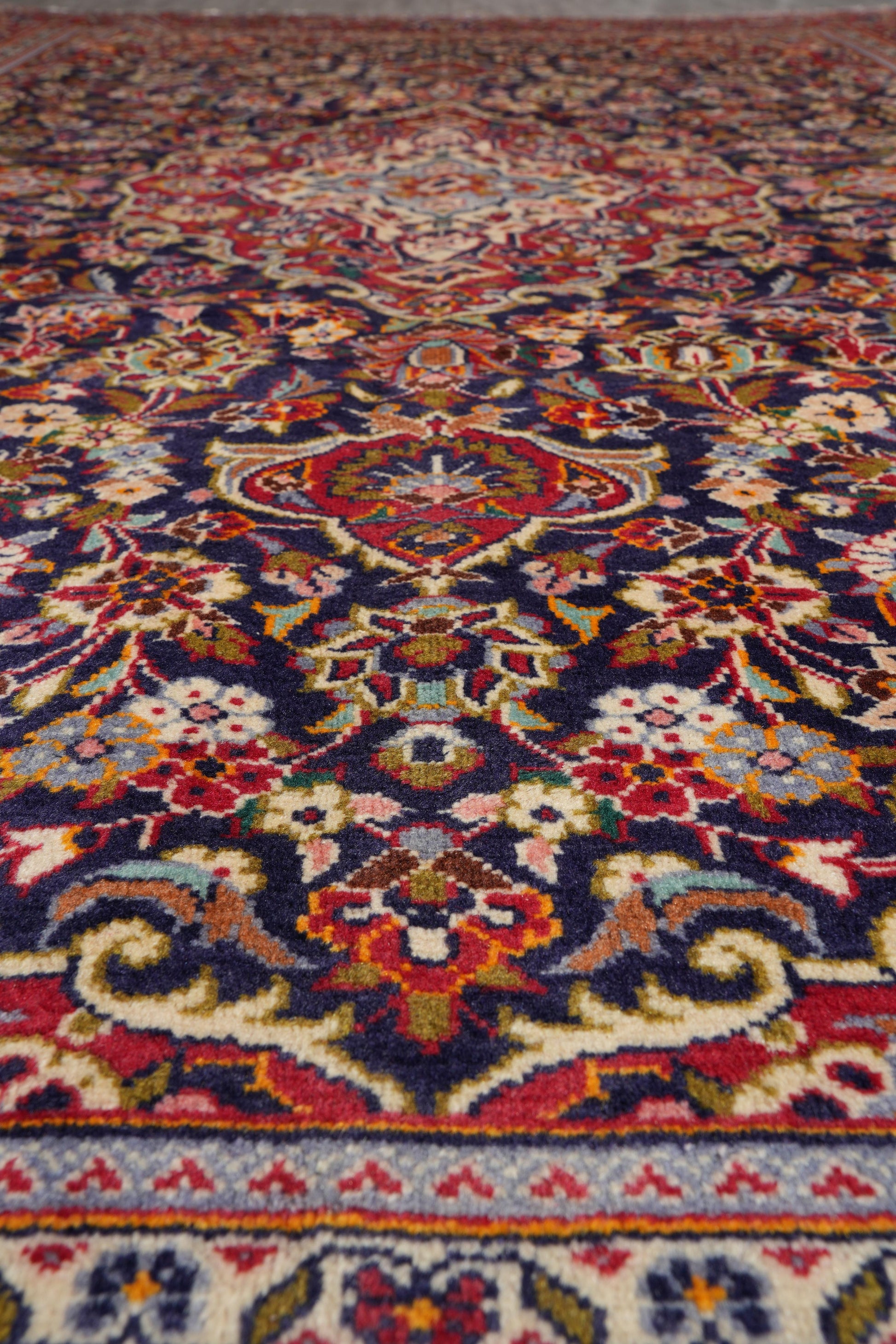 Kashan-style navy rug, color balance showing navy field against ivory medallion