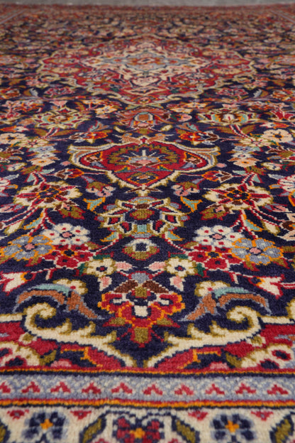 Kashan-style navy rug, color balance showing navy field against ivory medallion