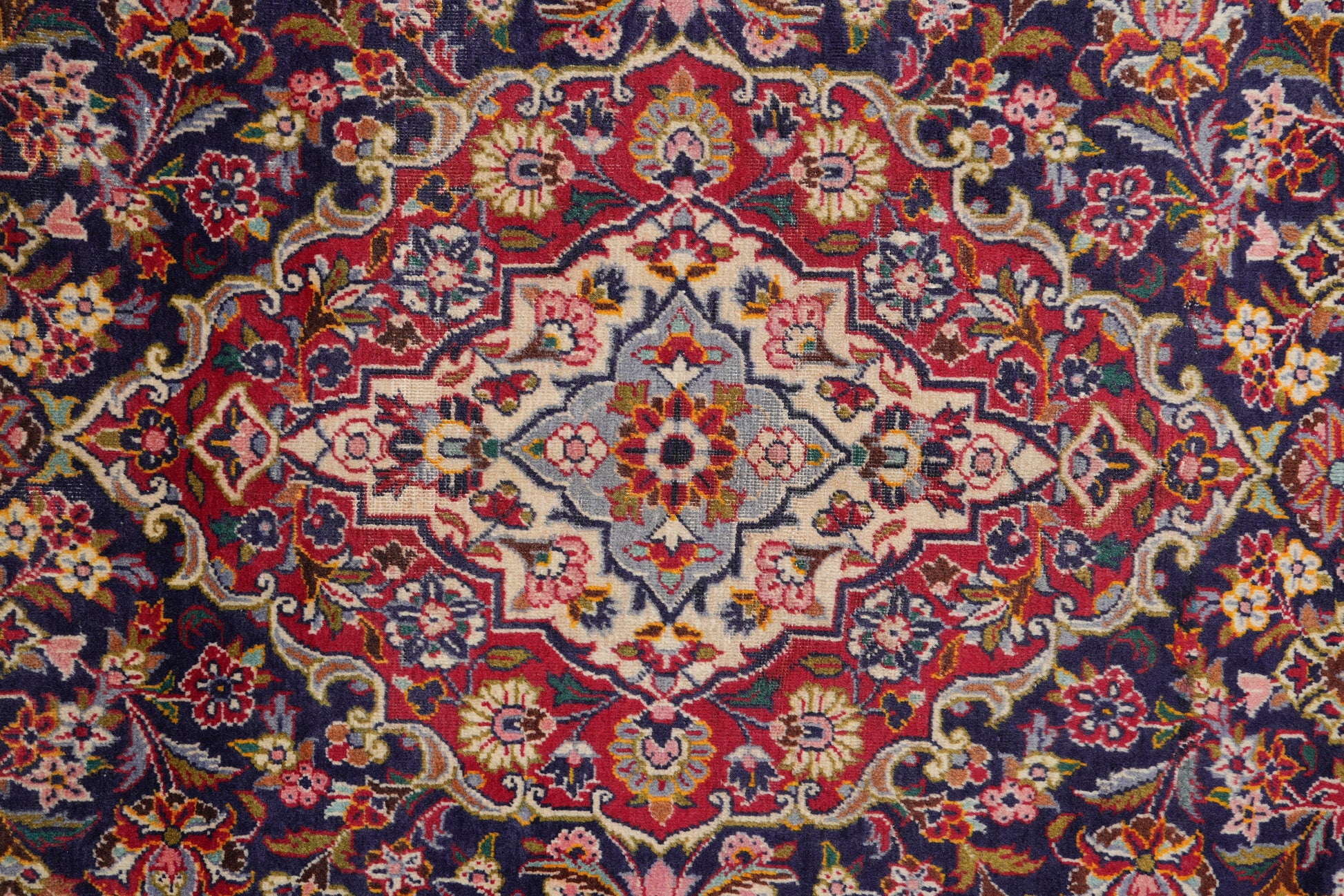 Kashan-style navy rug, alternate corner with floral continuity