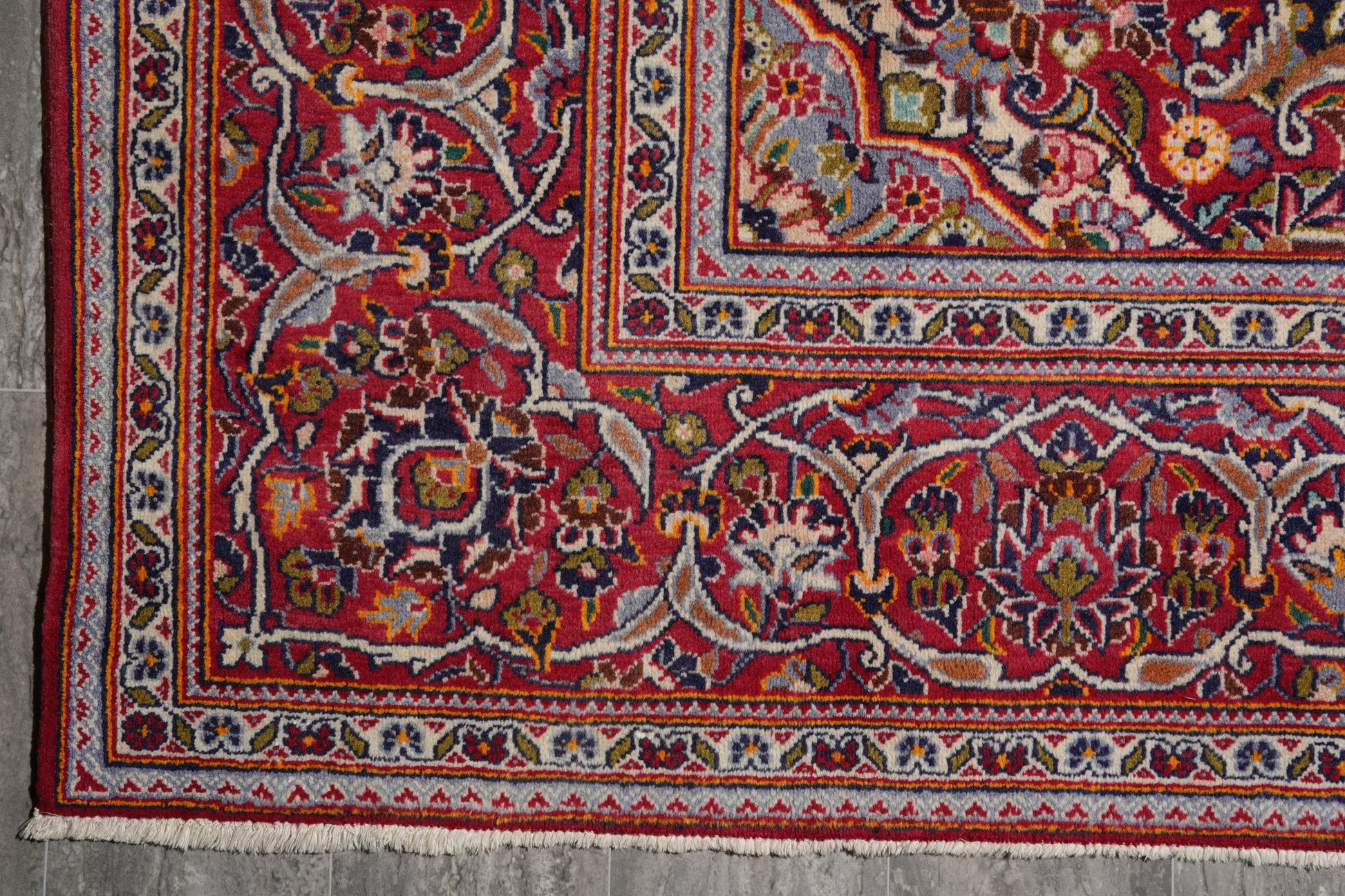 Kashan-style navy rug, partial overhead view in natural light