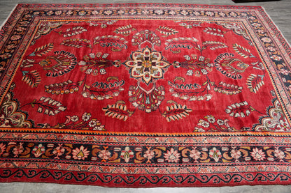 Vintage traditional floral rug, central medallion close-up in red and ivory