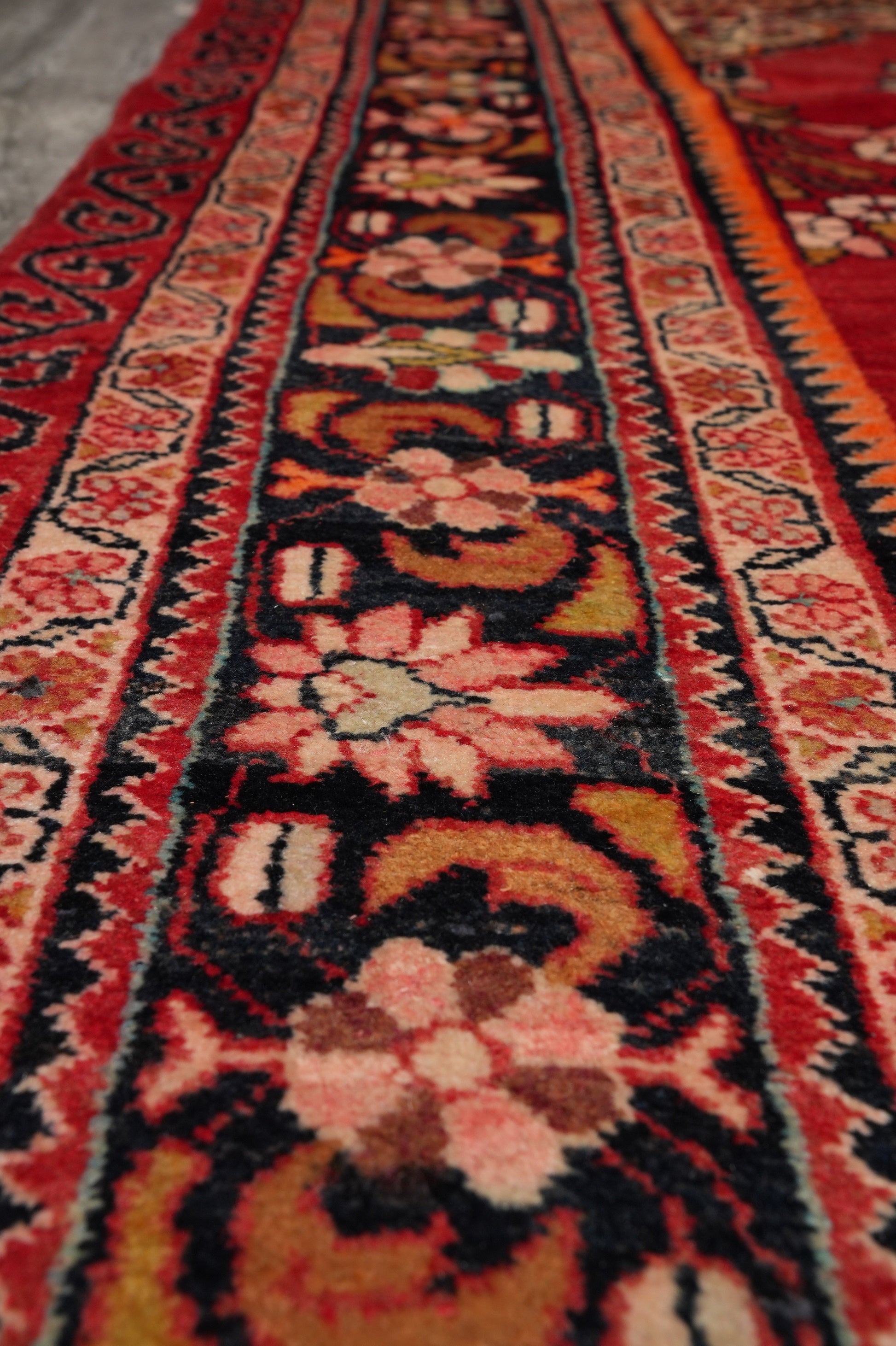 Vintage traditional floral rug, color balance close-up showing red field