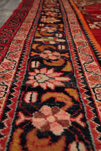 Vintage traditional floral rug, color balance close-up showing red field