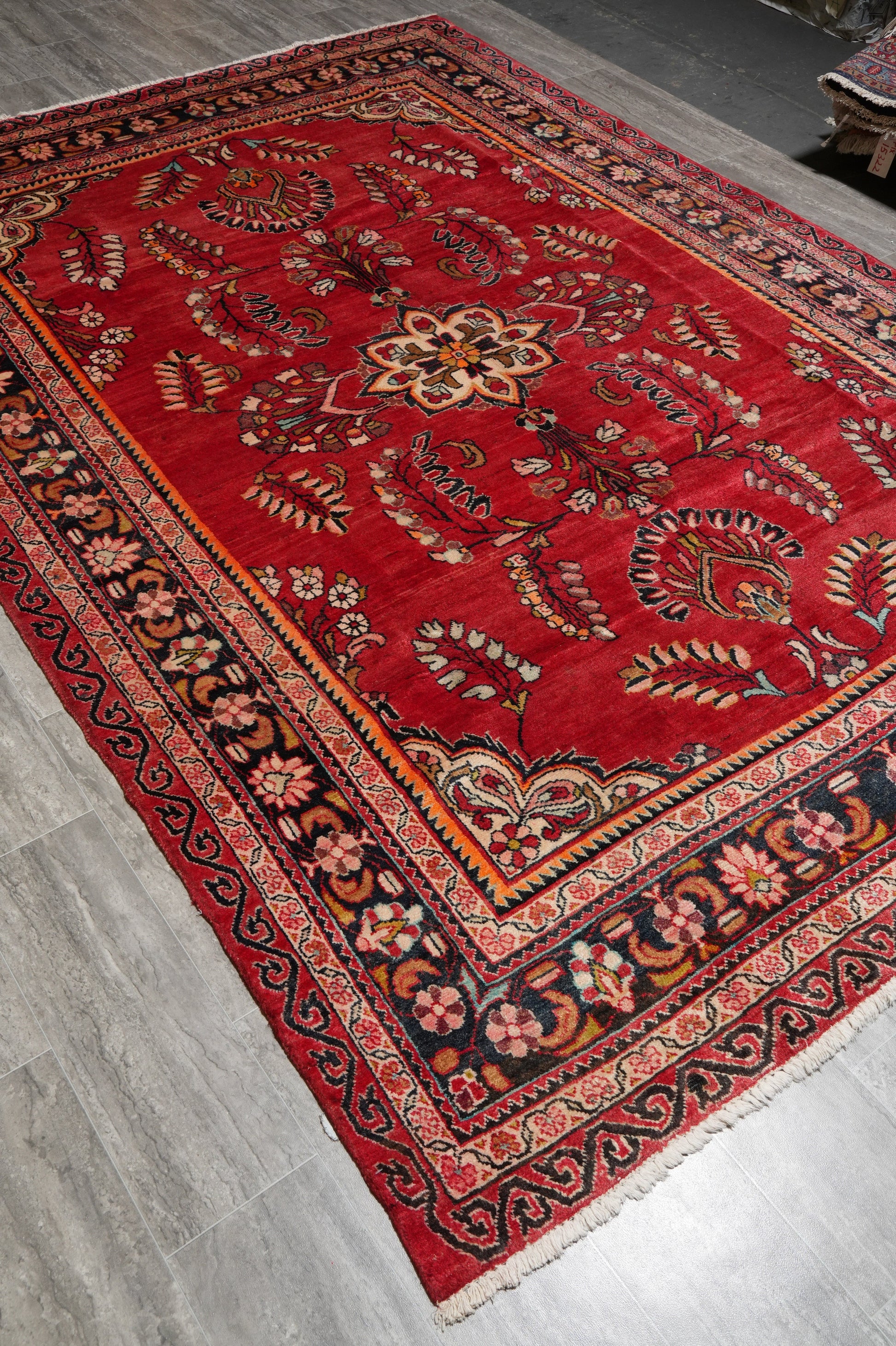 Vintage traditional floral rug, partial overhead view in natural light