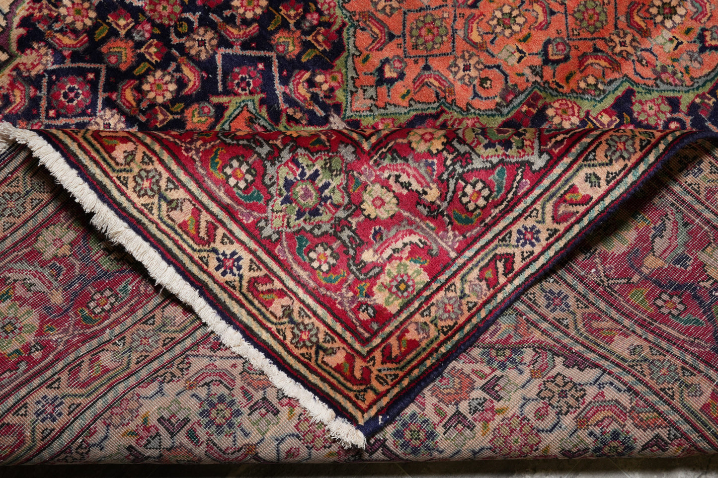 Tabriz-style Mahi rug, mid-field fish-and-vine detail