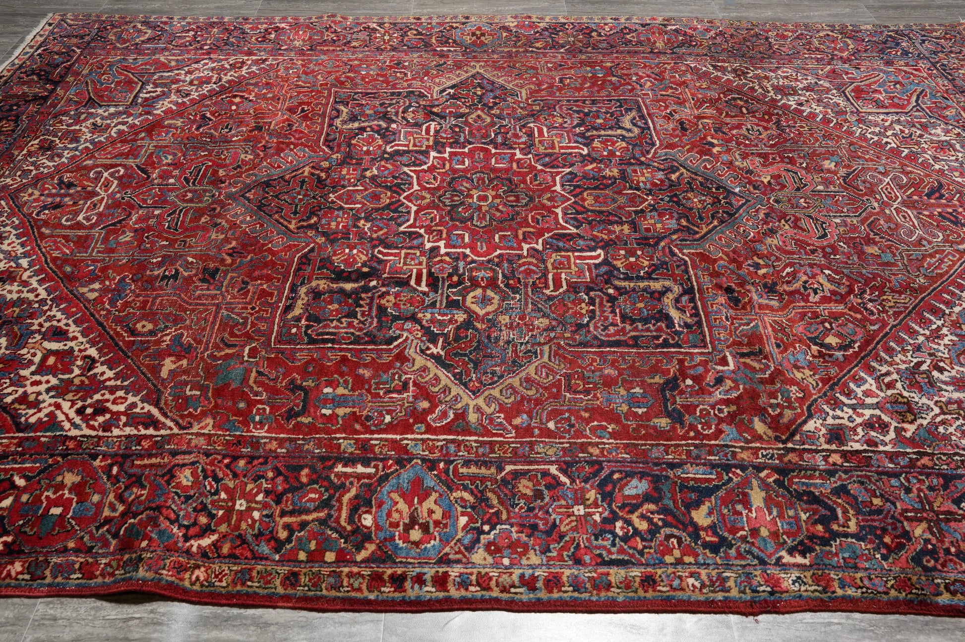 Strong tribal Heriz-style rug, central tribal medallion close-up in ivory and navy
