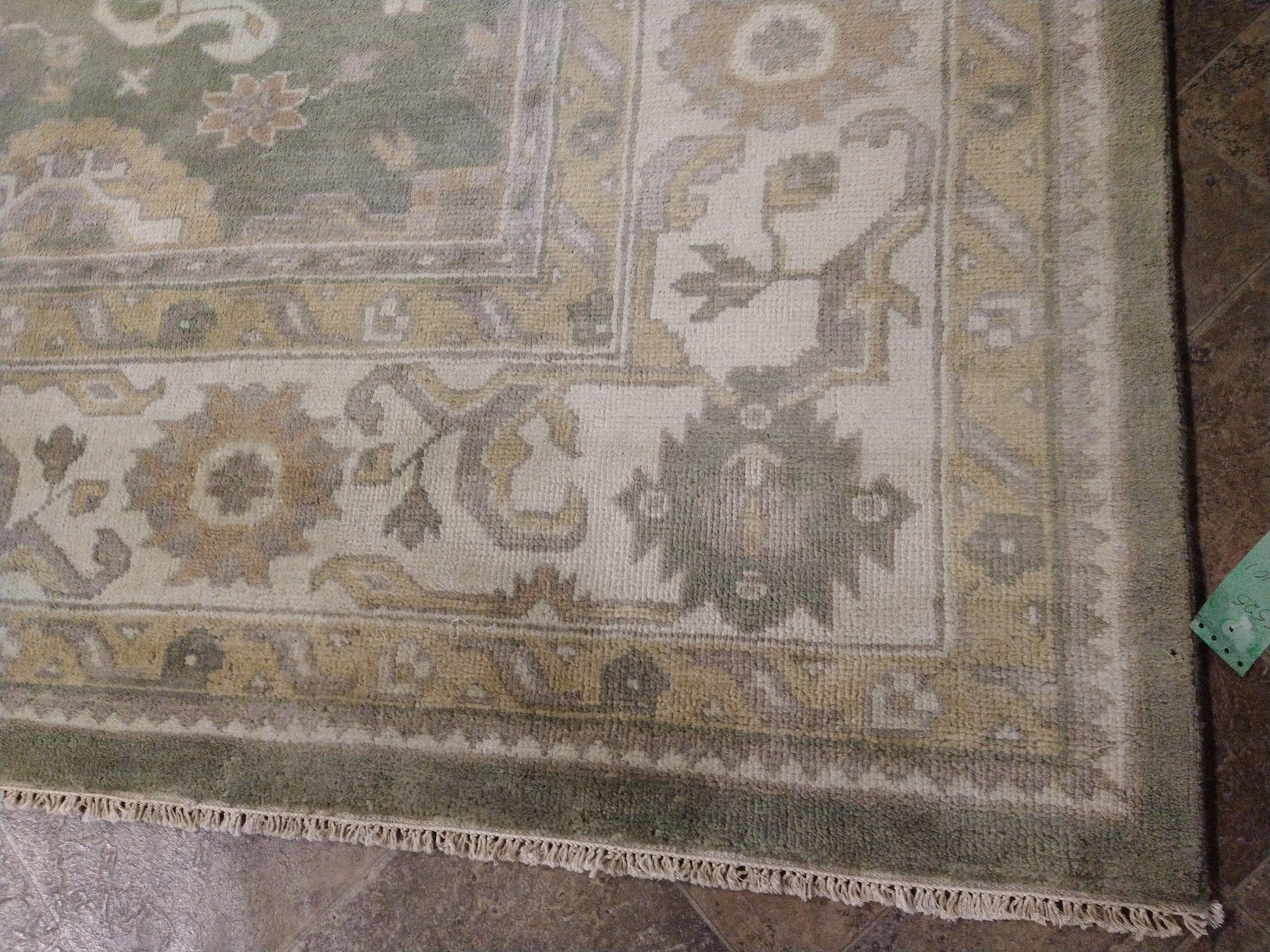 Oushak sage rug, ivory border pattern close-up