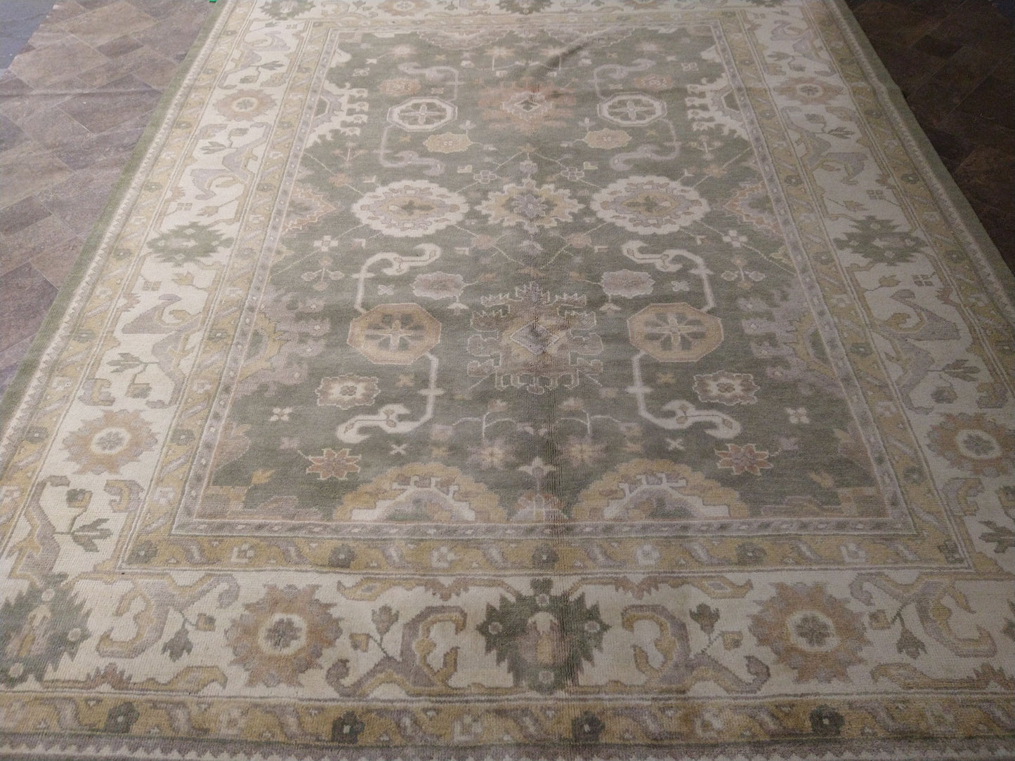 Oushak sage rug, color balance close-up of sage and rust accents