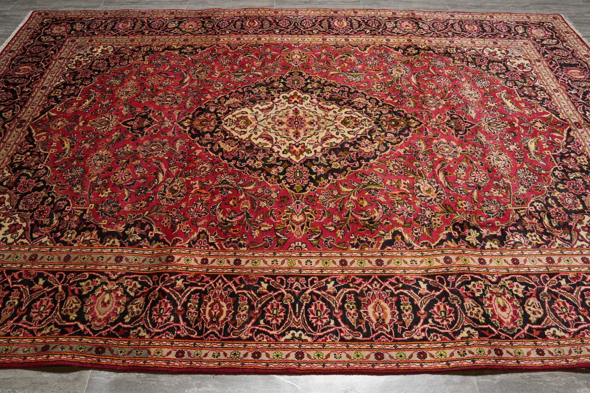 Kashan-style rug, central floral medallion close-up in ivory and navy