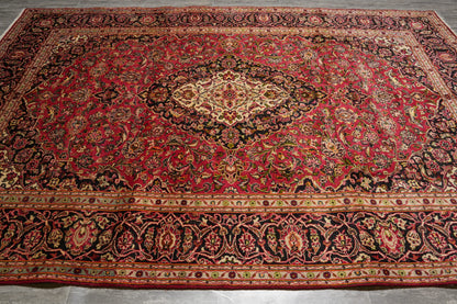 Kashan-style rug, central floral medallion close-up in ivory and navy