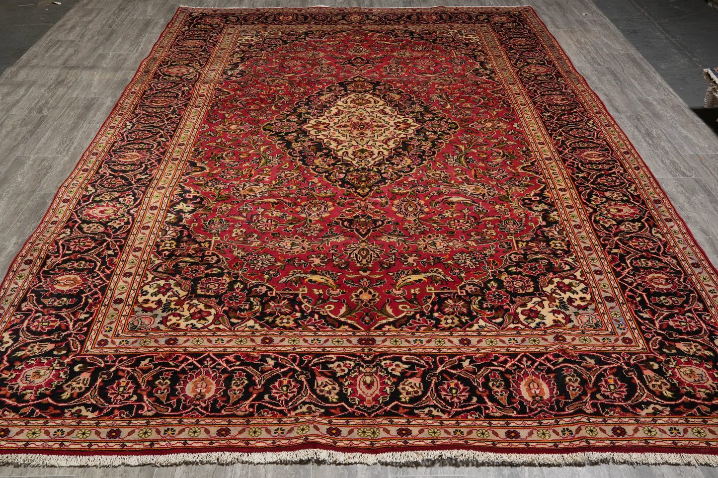 Kashan-style rug, curvilinear floral detail on red field
