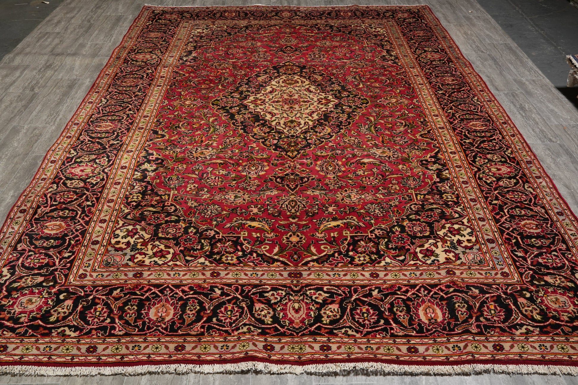 Kashan-style rug, curvilinear floral detail on red field