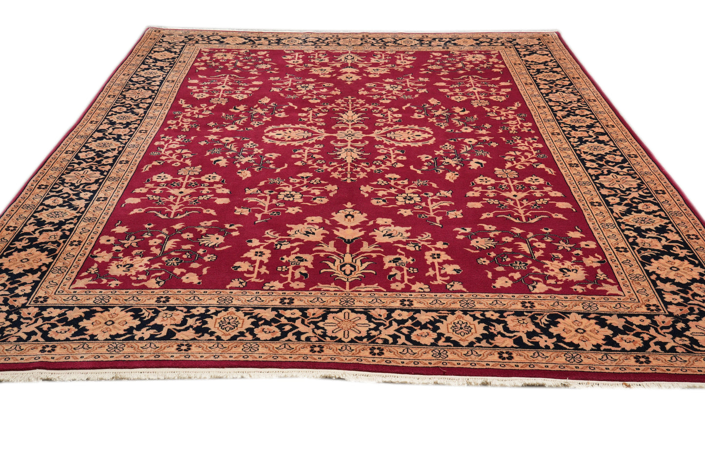 Sarouk-pattern wool rug, central floral medallion close-up in burgundy and ivory
