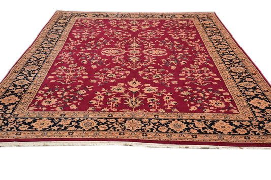 Sarouk-pattern wool rug, central floral medallion close-up in burgundy and ivory